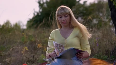 Henchka leafs through and examines a book with photographs. Stock Footage 161426203