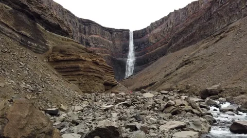 Hengifoss waterfall between red-layered basalt cliffs, Iceland Stock Footage 346440438