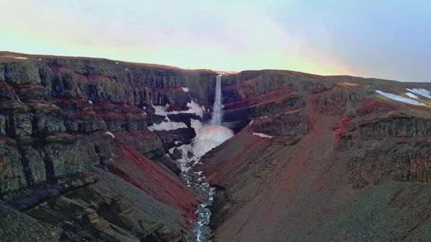 Hengifoss waterfall cascading over dramatic stratified basalt rock formations Stock Footage 345483212