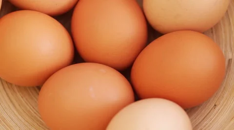 Henn eggs in basket on rotating stand shot from above Stock Footage 50831198