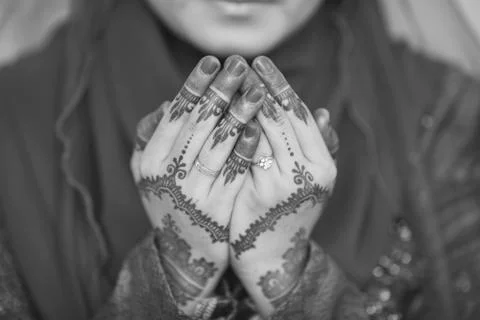 Henna and wedding ring on bride hand, pray for doa session. Stock Photos