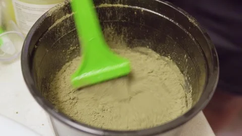 Henna powder mixing process with water in cosmetic bowl Stock Footage 341802037