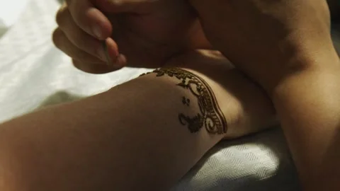 Henna stain is applied to woman's arm in traditional Asian design Stock Footage 335125348