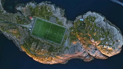 Henningsvaer football field in Lofoten, Norway - aerial drone footage Stock Footage