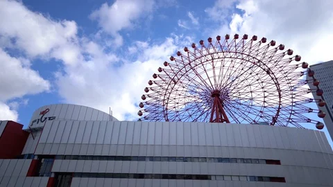 HEP Five ferris wheel is seen over blue sky near Hankyu Umeda Station Stock Footage 98992115