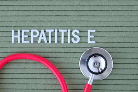 Hepatitis E- text from white letters on  green background with  stethoscope,  Fotos de archivo
