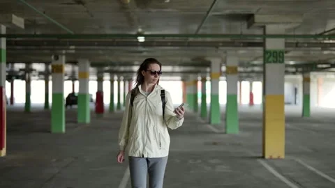 Her active use of a mobile phone anywhere emphasizes that she is always in touch Video stock 274876534