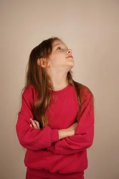 Her composed posture highlights her strong presence. The bright setting frames Stock Photos