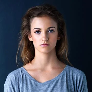 Her expression is unreadable. Studio shot of an expressionless teenage girl Stock Photos