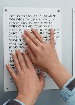 Her hands reading Braille table. Health and social adaptation Stock Photos