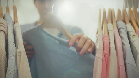 In her home wardrobe, a stylish white housewife chooses clothes based on cur Stock Footage 265076602