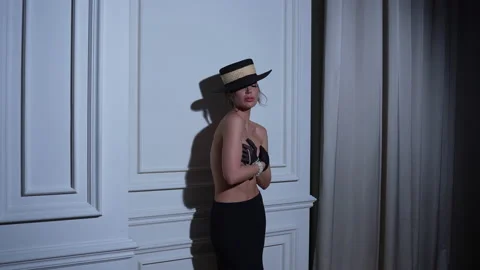 Her stunning black hat adds a touch of mystery to the image. 库存影片 239898645