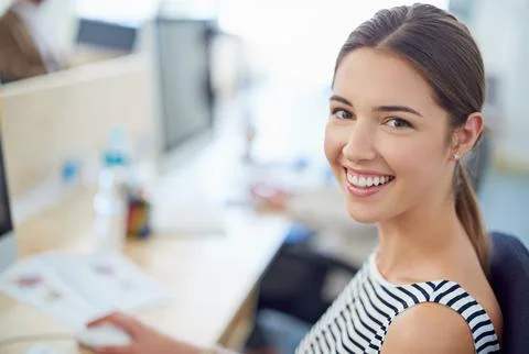 Her talent is first-class. Portrait of a young office worker sitting at her Stock Photos