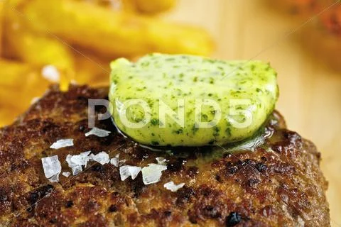Herb butter melting on burger Stock Photos