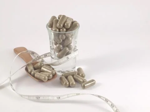 Herb in capsule pill Stock Photos