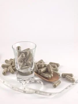 Herb in capsule pill Stock Photos