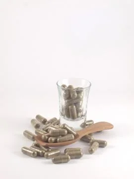 Herb in capsule pill Stock Photos