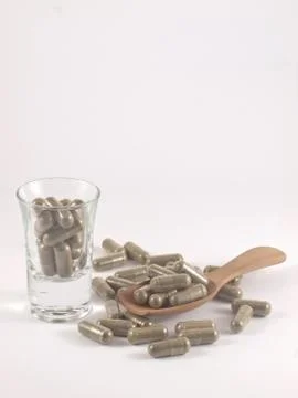 Herb in capsule pill Stock Photos