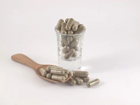 Herb in capsule pill Stock Photos