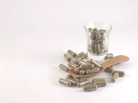 Herb in capsule pill Stock Photos