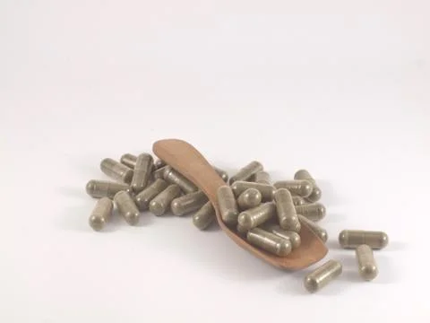 Herb in capsule pill Stock Photos