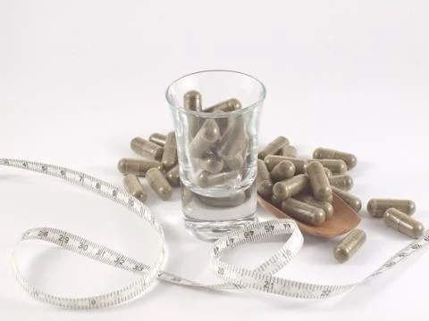 Herb in capsule pill Stock Photos