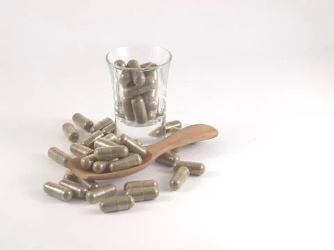 Herb in capsule pill Stock Photos
