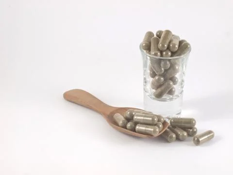 Herb in capsule pill Stock Photos