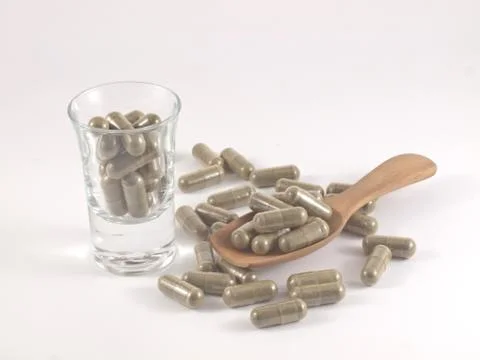 Herb in capsule pill Stock Photos