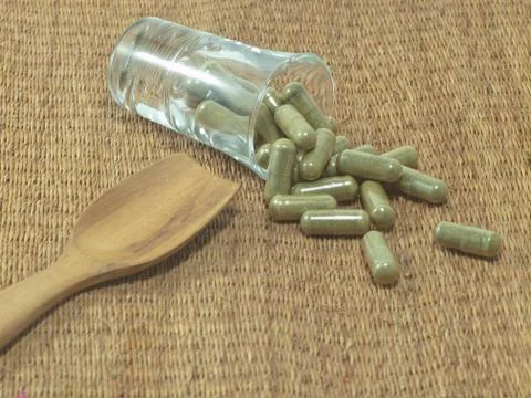 Herb in capsule pill Stock Photos
