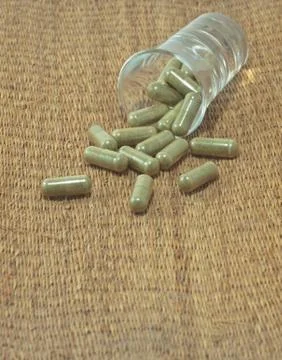 Herb in capsule pill Stock Photos