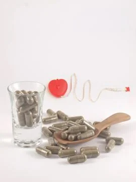 Herb in capsule pill Stock Photos