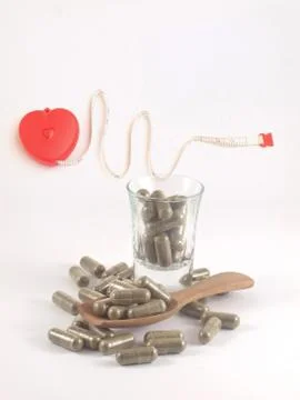 Herb in capsule pill Stock Photos