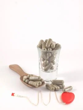 Herb in capsule pill Stock Photos