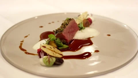Herb Crusted Meat Slices with Dark Sauce, Fine Dining Plate, Close Up Shot Stock Footage 341346109