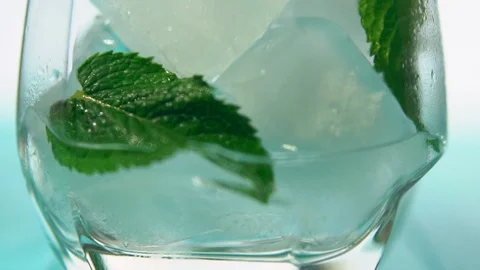 Herb leaves sitting in cup as it fills with water Stock Footage 94052986