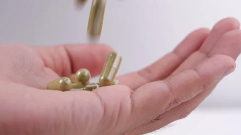 Herb pills falling into a man hand in 4K Resolution Stock-Footage 132227527