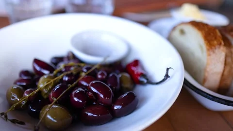 Herb Roasted Olives and Bread on Rustic Table Stock Footage 308448155