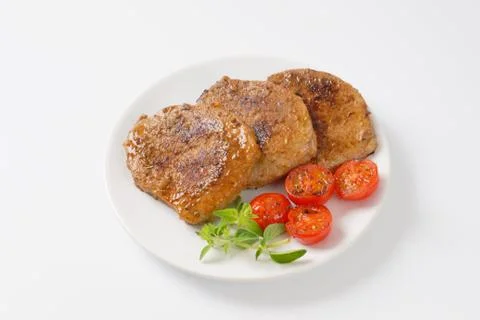 Herb rubbed pork chops Stock Photos