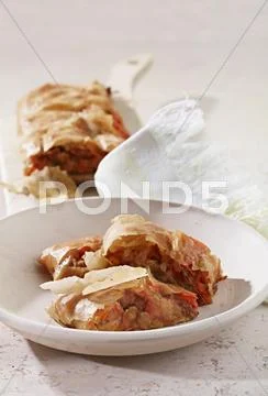 Herb strudel filled with meat and vegetables Stock Photos