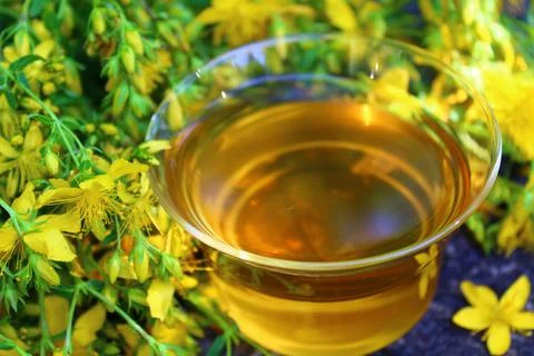 Herb tea on an old weathered tree trunk Stock Photos
