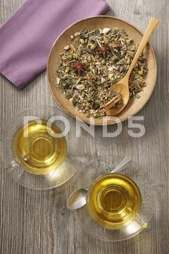 Herb tea with spices: loose leaf tea on a plate and brewed in glass cups Stock Photos