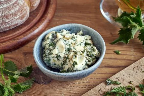 Herbal bread spread made from butter and young nettles collected in spring Stock Photos