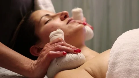 Herbal compressing balls massage side view Stock Footage 71350378