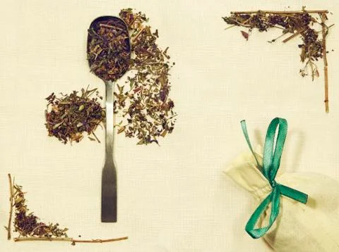 Herbal flat lay of different herbs on linen fabric with a spoon and pouch Stock Photos