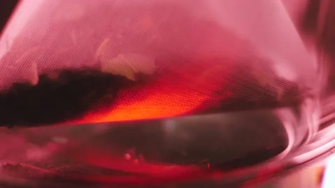 Herbal flower-fruit tea in a microplastic bag is placed in a transparent cup. Stock Footage 184475763