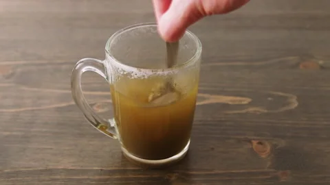 Herbal medicine tablet dissolves in hot water. Stirring. Sequence of cuts Video stock 130399471