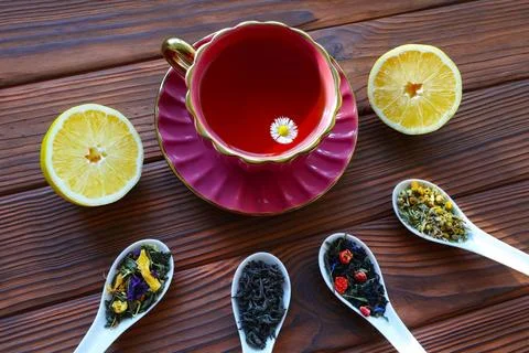 Herbal tea with assorted loose leaf herbs and lemon slices. A vibrant Stock Photos