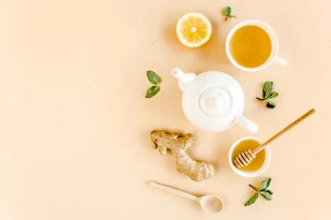 Herbal tea with mint, ginger, lemon, honey and other herbs on yellow background Stock Photos