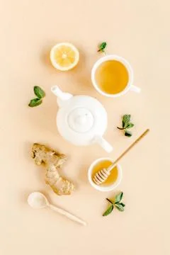 Herbal tea with mint, ginger, lemon, honey and other herbs on yellow background Stock Photos